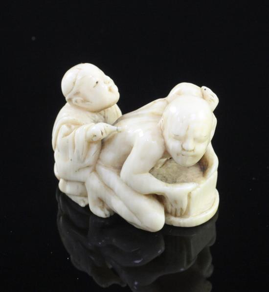 A Japanese ivory netsuke of a rat catcher and a boy, Meiji period, length 3.9cm